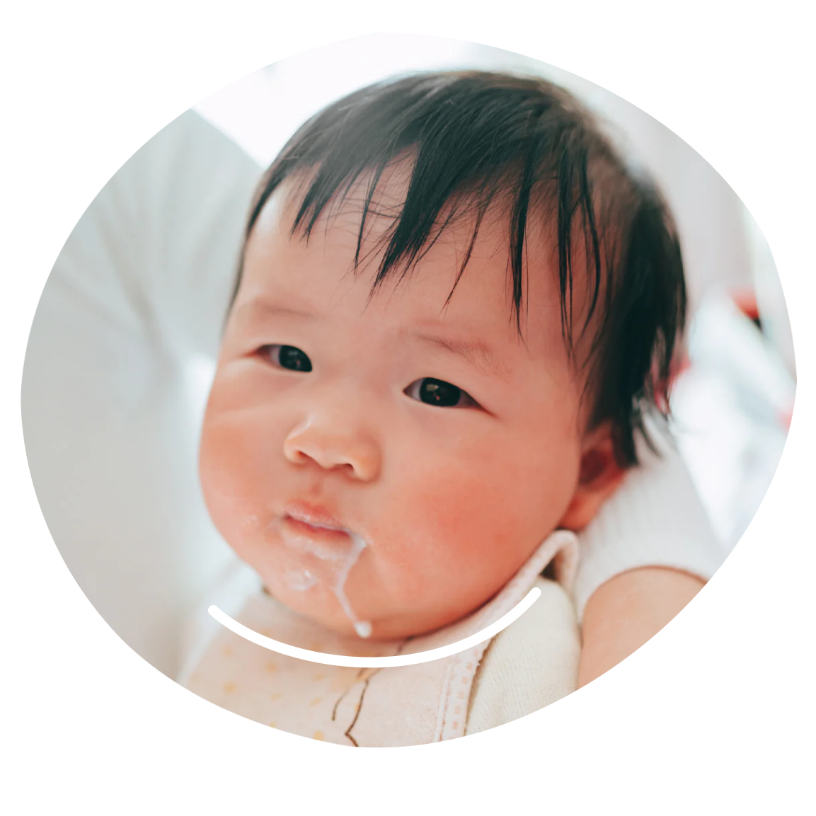 Baby's face with formula on chin